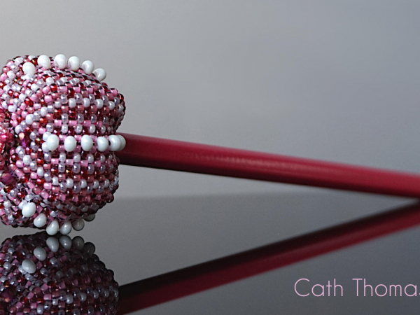 Beaded sea urchin as a pencil topper